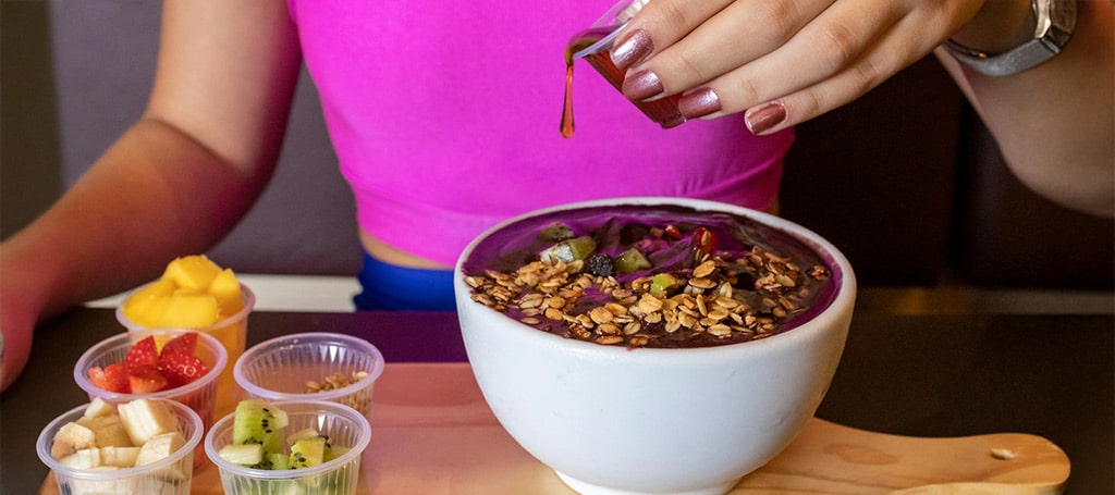Women Eating from Açaí Bowl