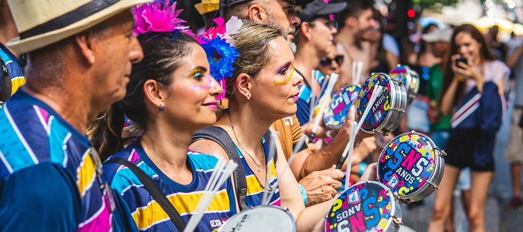 Revelers playing musical instruments at street carnival