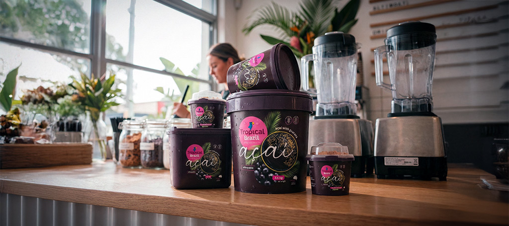 Tropical Brazil Açaí bulk tubs displayed on a professional smoothie bar counter in Australia, highlighting commercial açaí pulp for cafés, gyms and bowl shops.